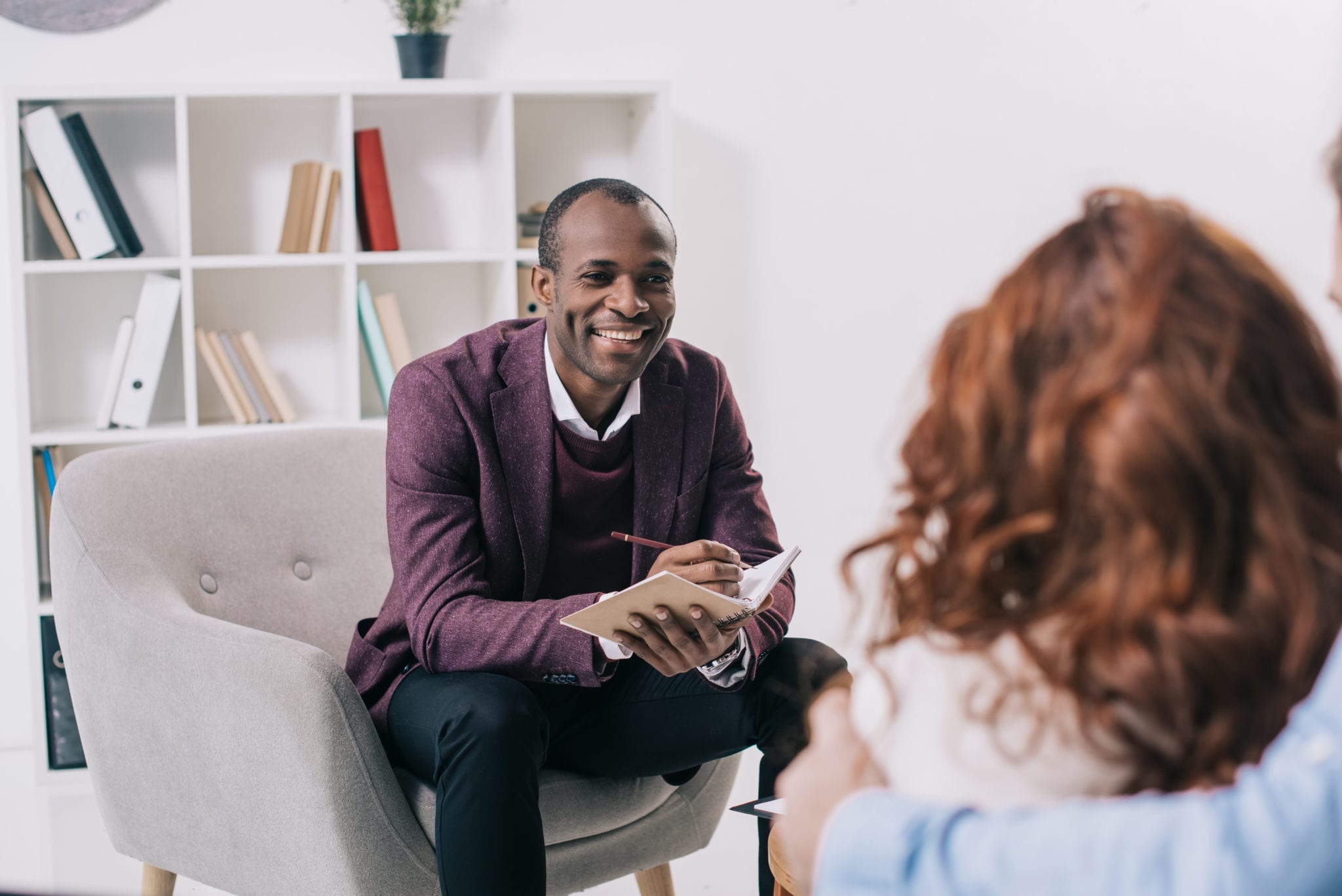 Smiling,African,American,Psychiatrist,Talking,To,Young,Couple